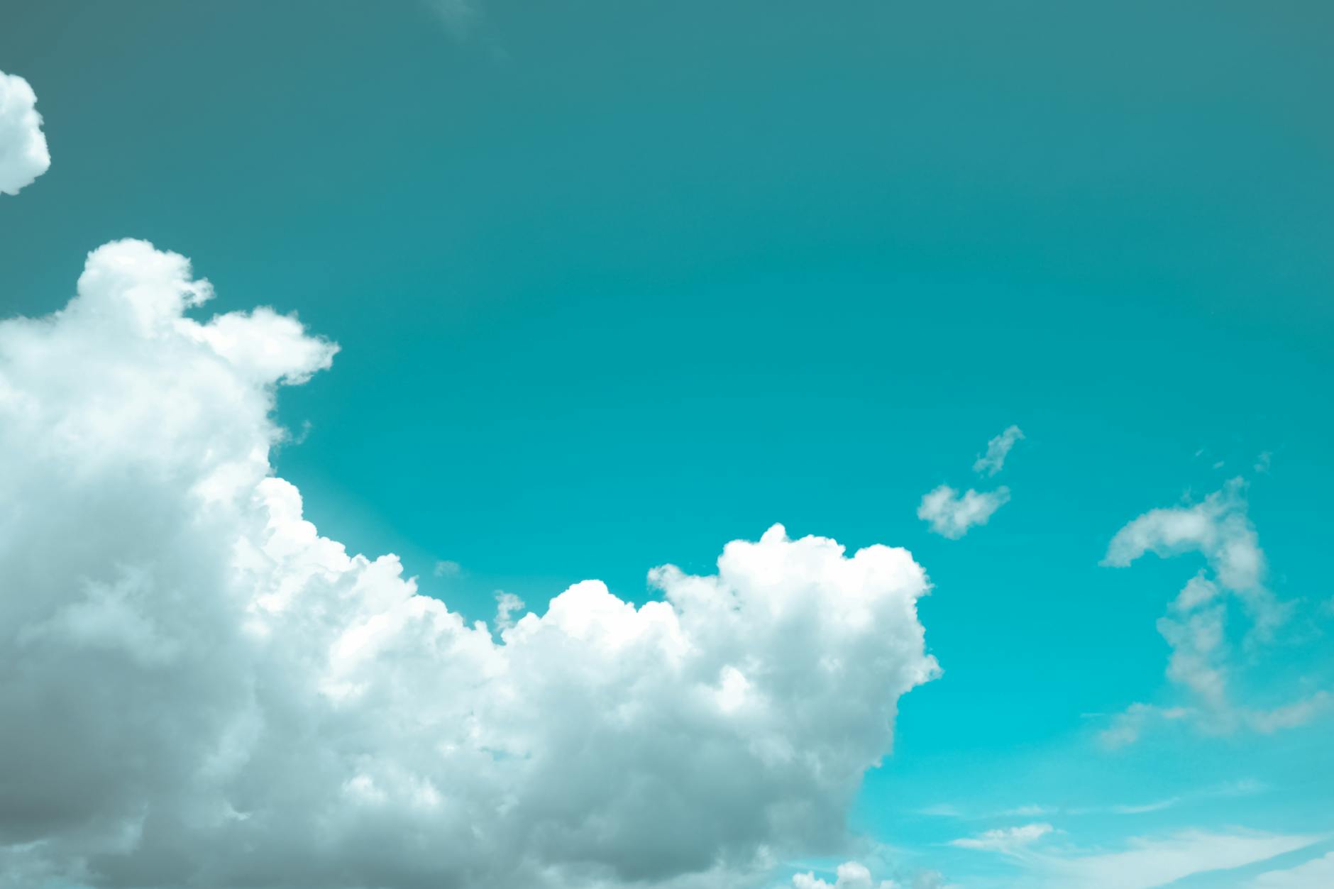 Bright and serene view of fluffy white clouds against a vibrant blue sky.