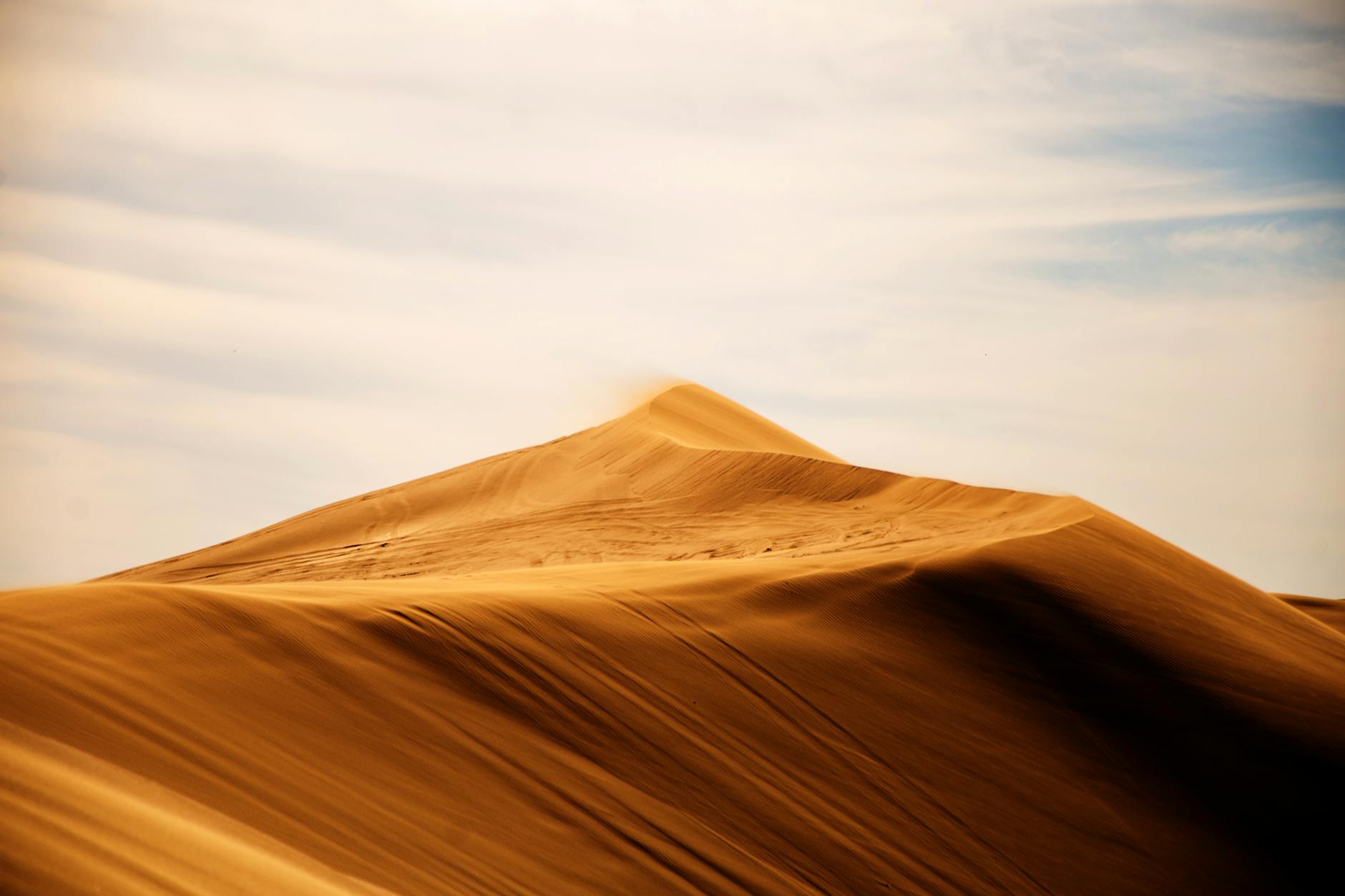Captivating view of sand dunes stretching under a serene blue sky in Caleu Caleu, Argentina. Captivating view of sand dunes stretching under a serene blue sky in Caleu Caleu, Argentina.
