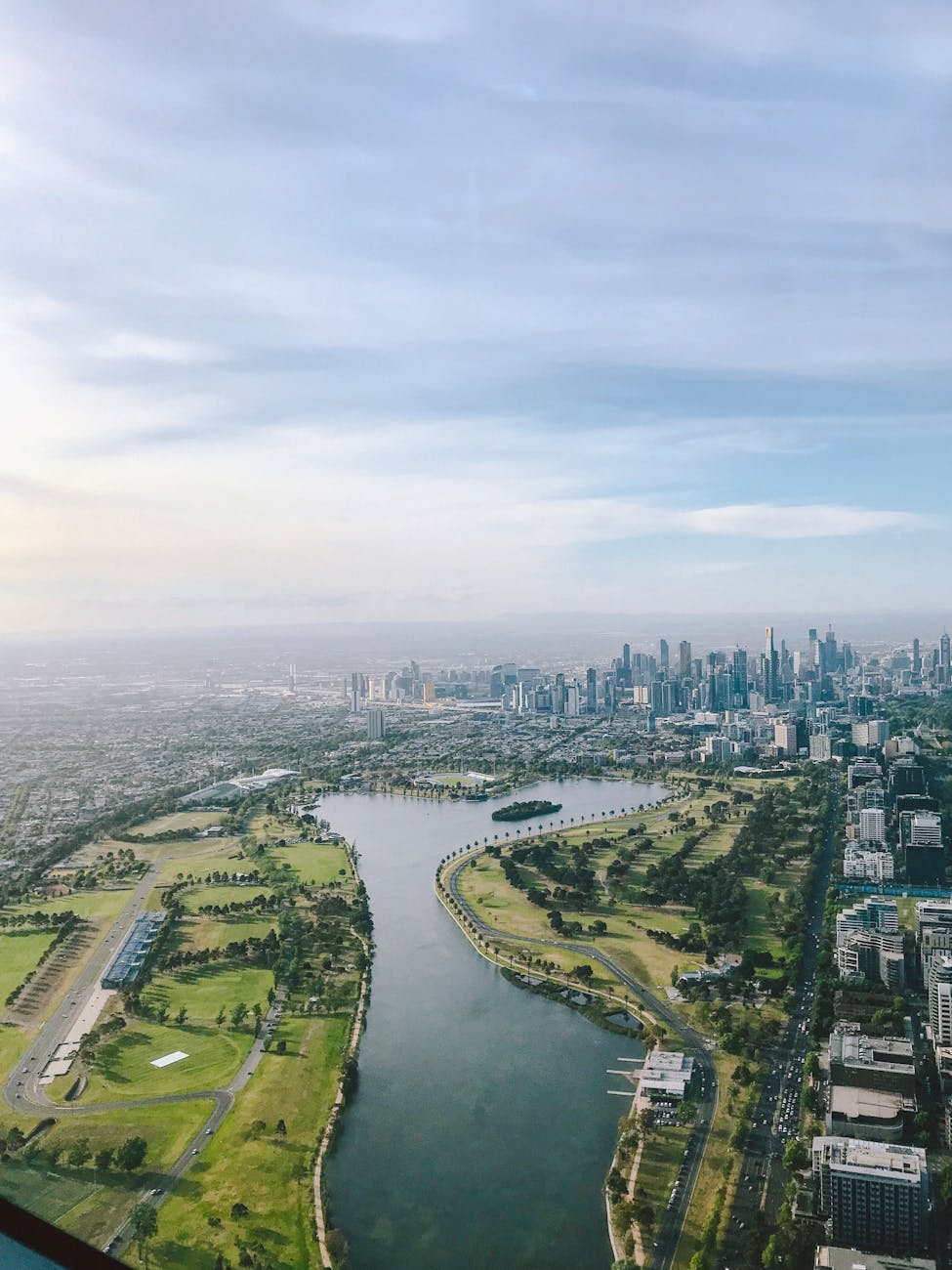 Breathtaking aerial view of Melbourne skyline along the Yarra River with lush greenery. Breathtaking aerial view of Melbourne skyline along the Yarra River with lush greenery.