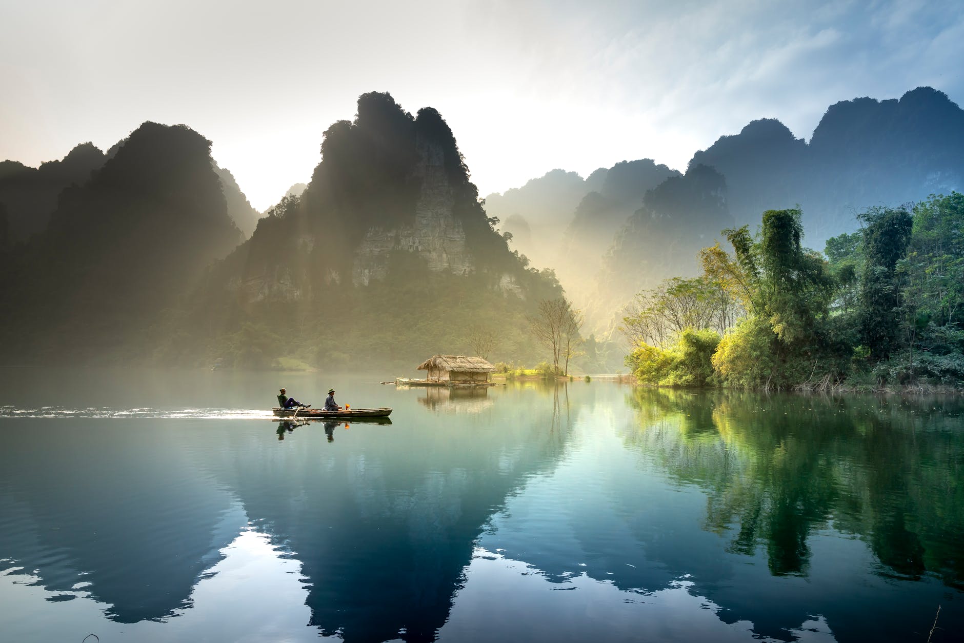 Tranquil lake with mountains reflecting at sunrise in Tuyên Quang, Vietnam. Tranquil lake with mountains reflecting at sunrise in Tuyên Quang, Vietnam.