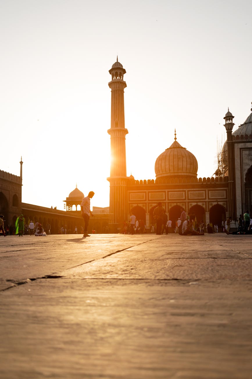 Beautiful evening view of Jama Masjid in New Delhi with people gathering at sunset. Beautiful evening view of Jama Masjid in New Delhi with people gathering at sunset.