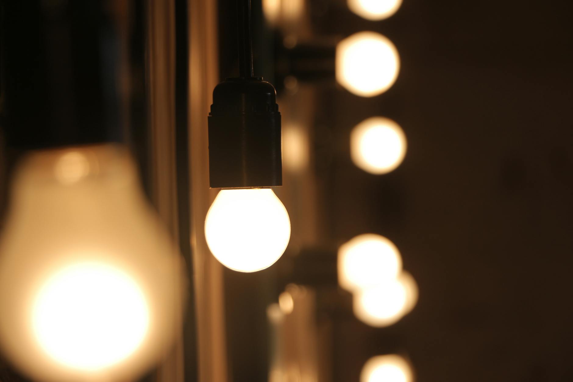 Close-up of glowing light bulbs creating a cozy atmosphere with soft bokeh effect. Close-up of glowing light bulbs creating a cozy atmosphere with soft bokeh effect.