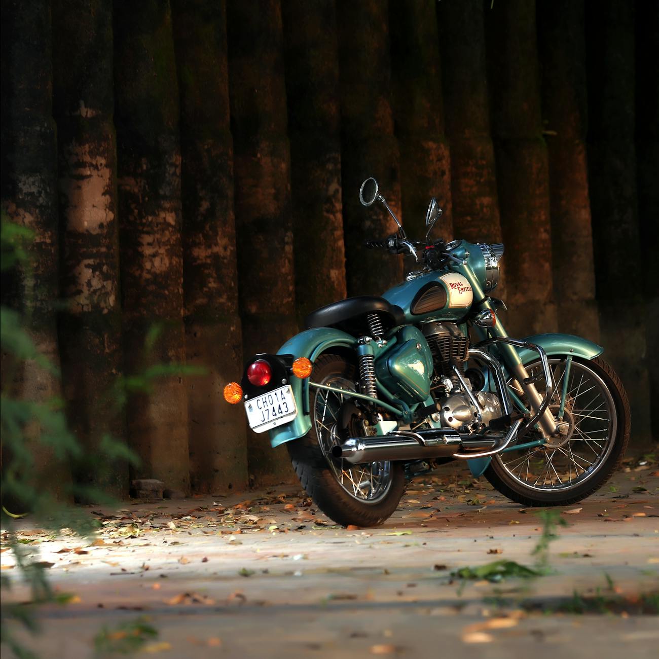 A classic retro motorcycle parked in a serene outdoor setting, exuding vintage charm and style.