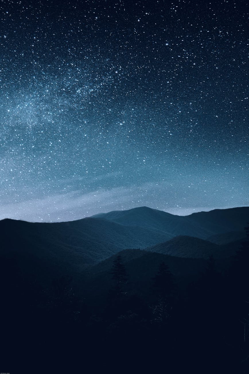 A breathtaking night sky full of stars over a silhouette of mountain ridges. A breathtaking night sky full of stars over a silhouette of mountain ridges.