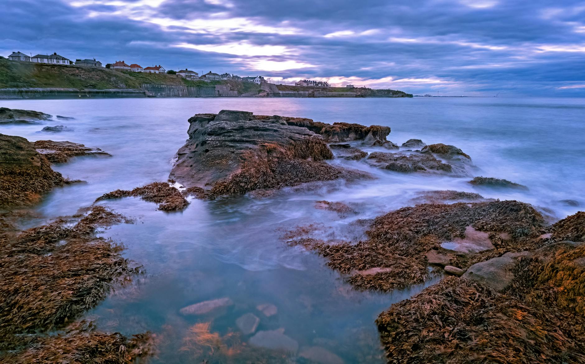 Breathtaking sunset view over rocky shoreline with dramatic clouds and waves. Breathtaking sunset view over rocky shoreline with dramatic clouds and waves.