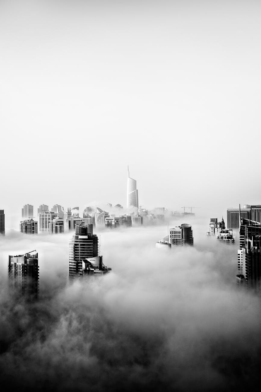 Stunning black and white panorama of Dubai skyline shrouded in fog, showcasing modern skyscrapers.