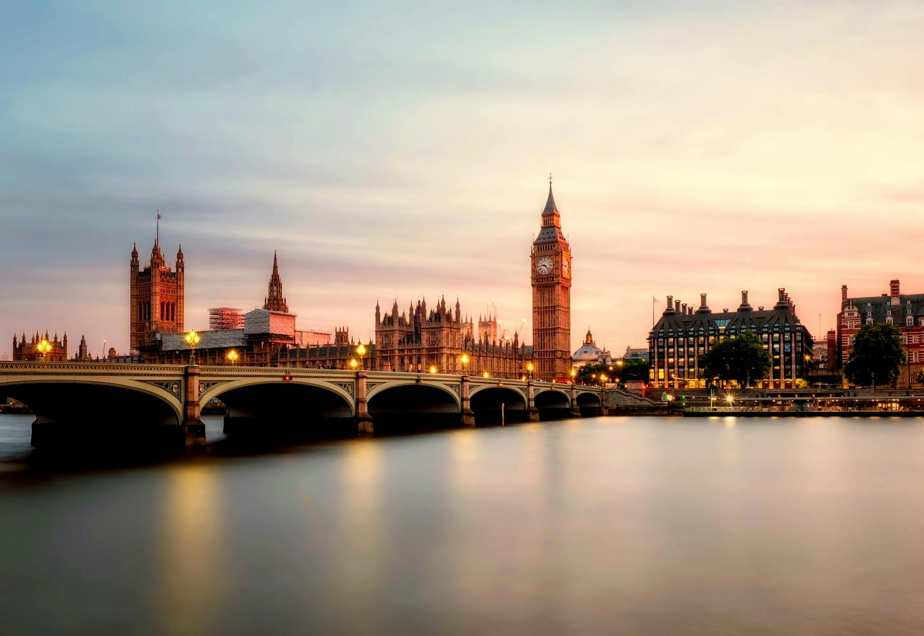 Scenic view of Big Ben and Westminster Bridge over the Thames River at sunset in London, UK. Scenic view of Big Ben and Westminster Bridge over the Thames River at sunset in London, UK.