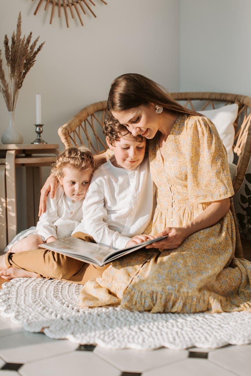Warm scene of mother reading a book with her children in a cozy home environment. Warm scene of mother reading a book with her children in a cozy home environment.