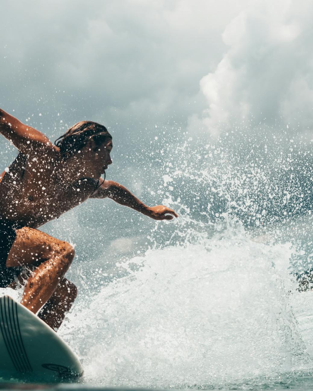 Energetic surfer rides ocean waves in tropical Indonesia, capturing the thrill of water sports. Energetic surfer rides ocean waves in tropical Indonesia, capturing the thrill of water sports.