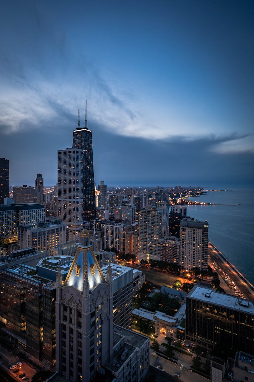 A breathtaking aerial view of Chicago’s skyline featuring the iconic John Hancock Center at twilight.