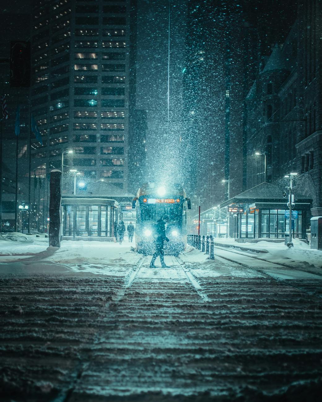 A snowy night scene with tram in downtown Minneapolis, highlighting urban winter charm. A snowy night scene with tram in downtown Minneapolis, highlighting urban winter charm.