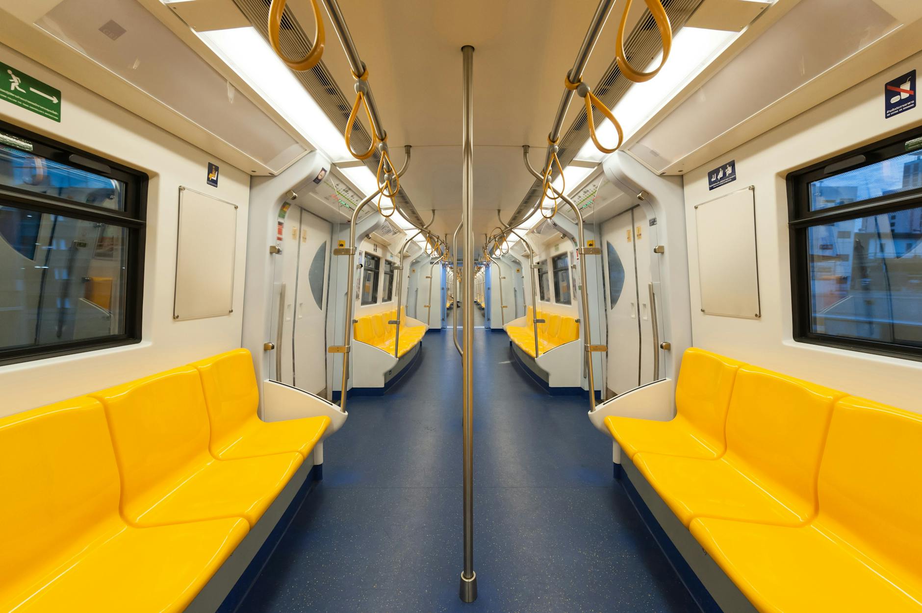Interior of a modern subway car with bright yellow seats and clean design, emphasizing public transportation. Interior of a modern subway car with bright yellow seats and clean design, emphasizing public transportation.