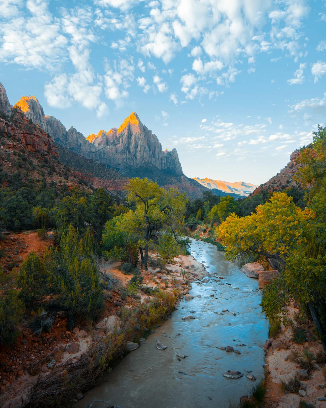 Majestic mountain landscape with a tranquil river in Zion National Park under a vibrant sky. Majestic mountain landscape with a tranquil river in Zion National Park under a vibrant sky.
