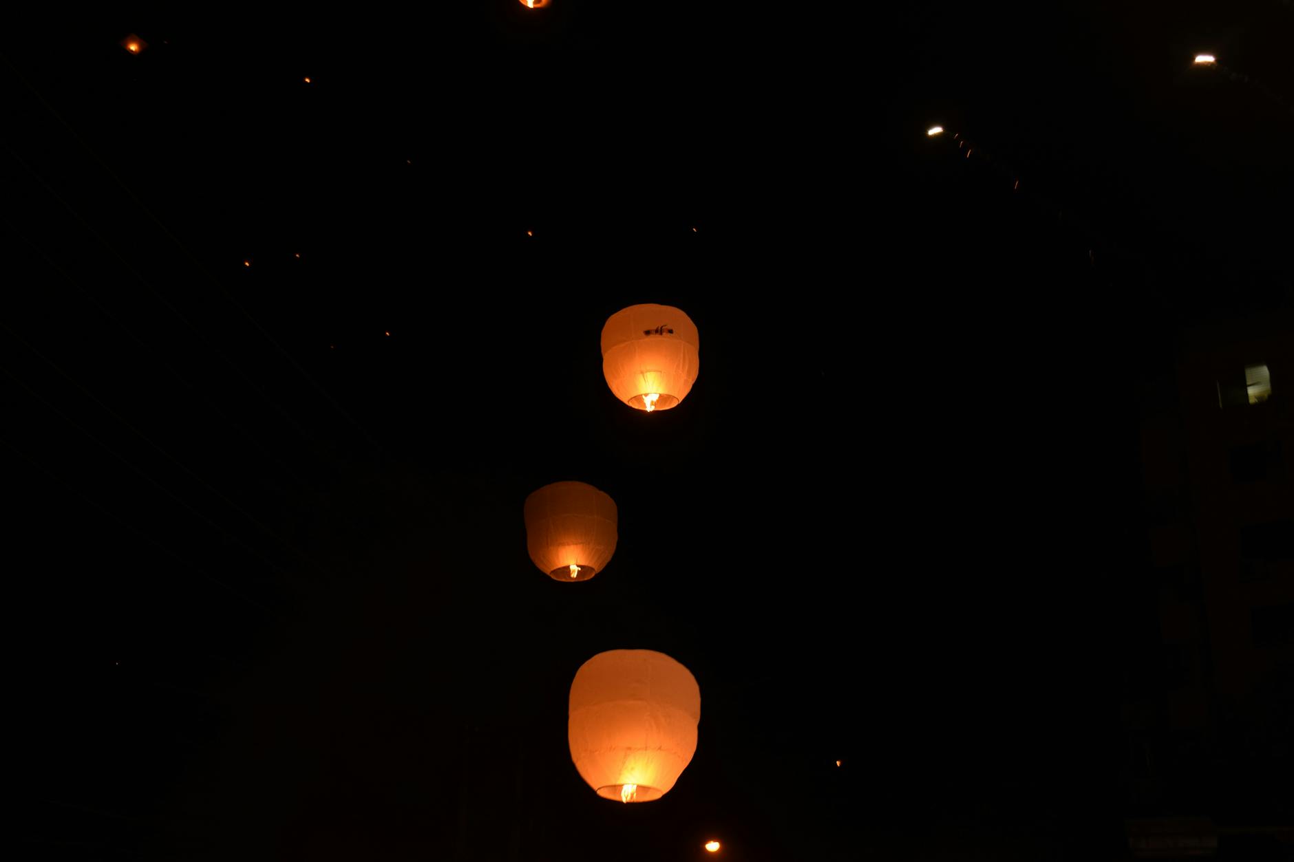 Sky lanterns glowing warmly as they ascend into the night sky. Sky lanterns glowing warmly as they ascend into the night sky.
