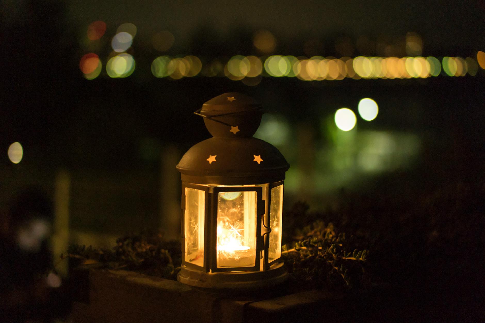 A glowing lantern creating a warm ambiance with bokeh lights in the background, ideal for festive themes. A glowing lantern creating a warm ambiance with bokeh lights in the background, ideal for festive themes.