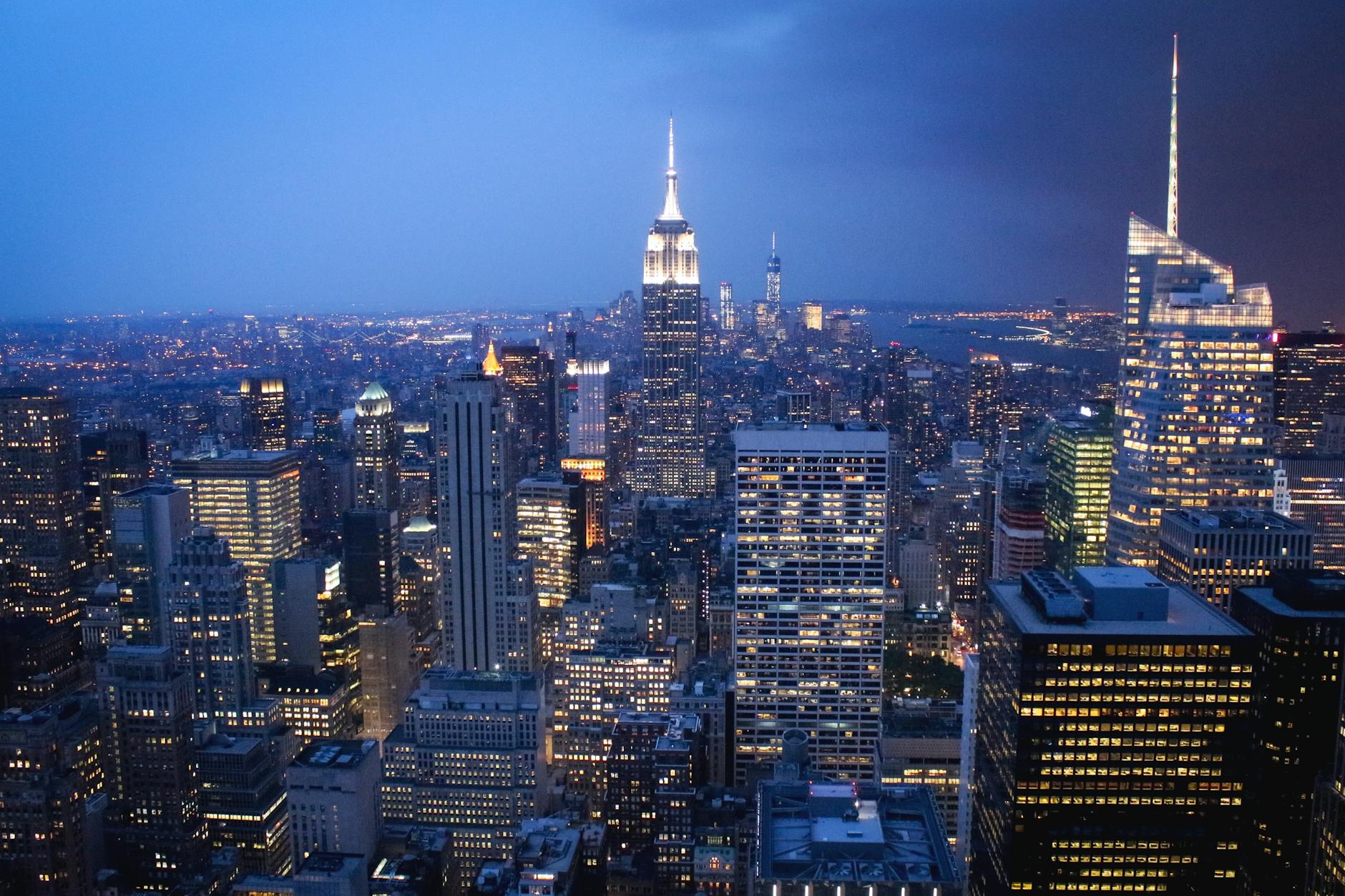 A stunning nighttime view of New York City skyline with illuminated skyscrapers.