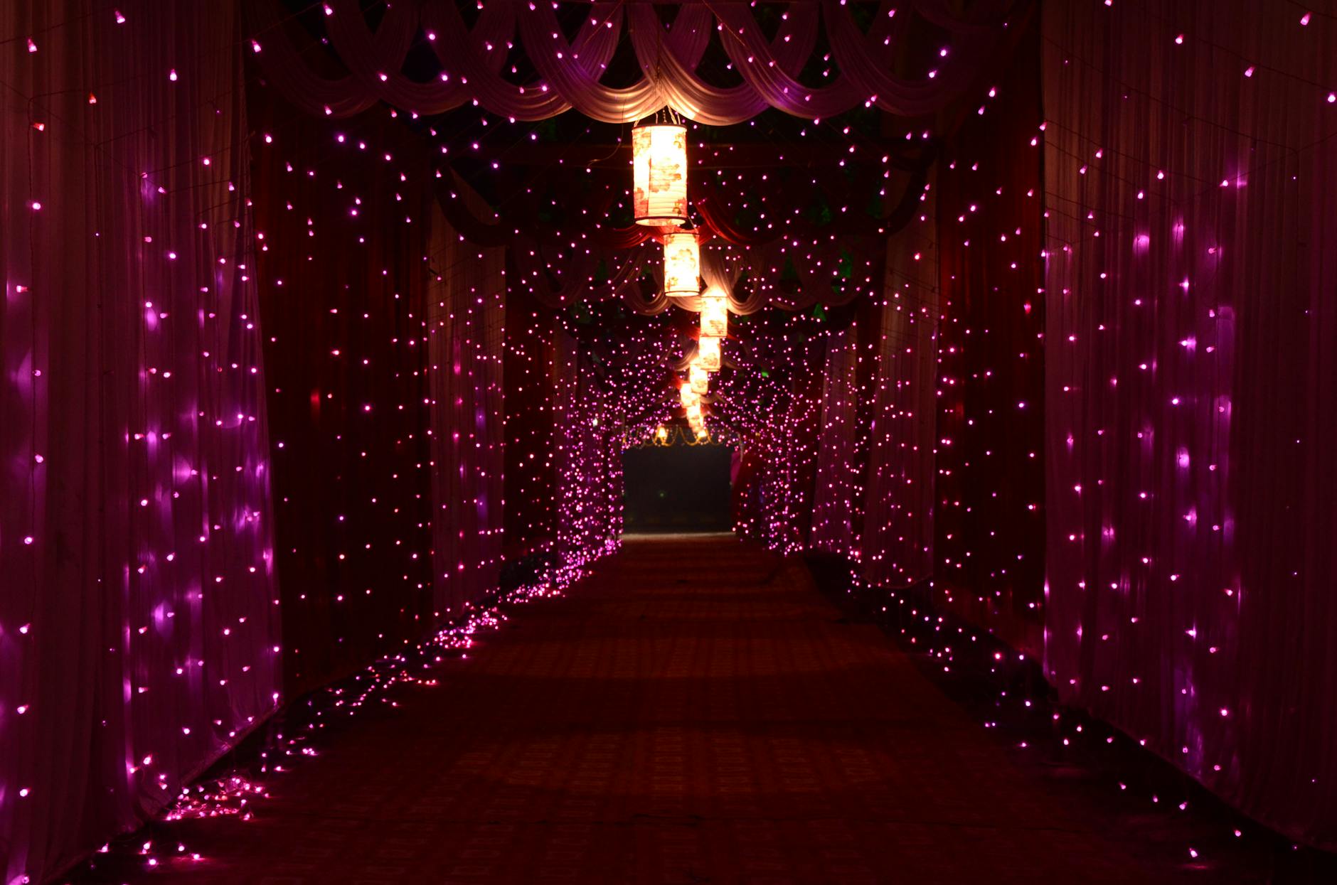 A mesmerizing corridor lit with vibrant purple lights creating a magical ambiance indoors. A mesmerizing corridor lit with vibrant purple lights creating a magical ambiance indoors.