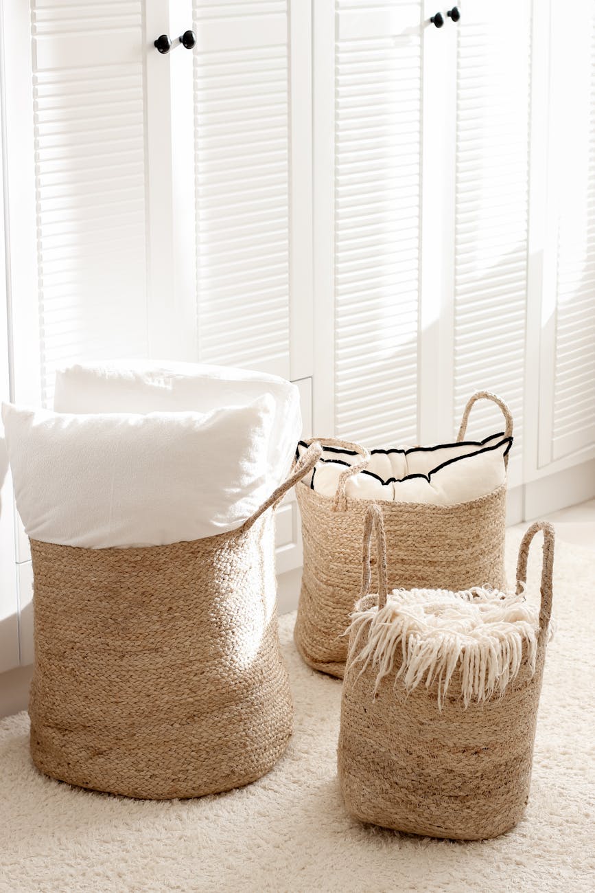 Elegant wicker baskets with soft textiles in a sunlit interior. Elegant wicker baskets with soft textiles in a sunlit interior.