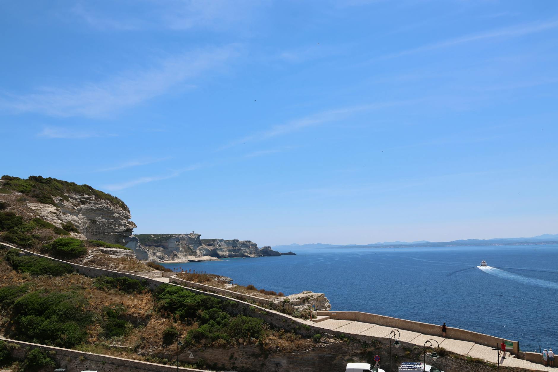 Stunning coastal landscape of Bonifacio’s cliffs with a boat on the Mediterranean Sea. Stunning coastal landscape of Bonifacio’s cliffs with a boat on the Mediterranean Sea.