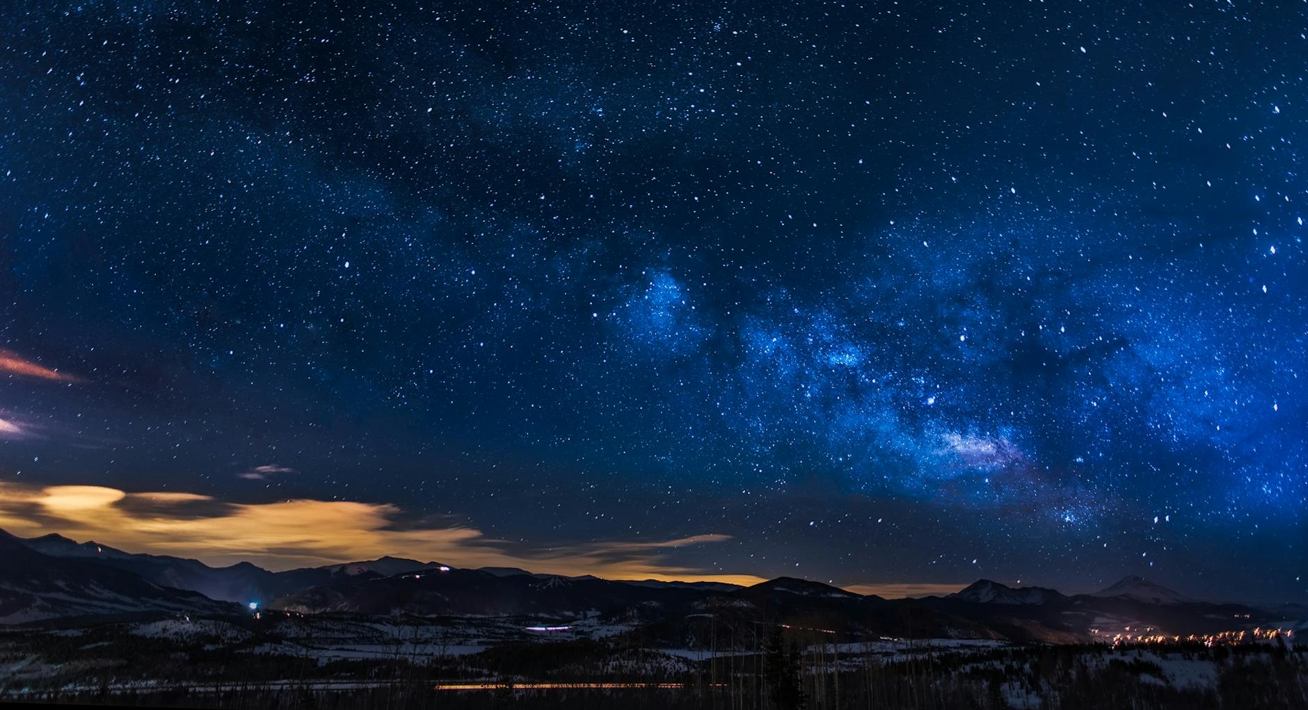 A breathtaking view of the Milky Way galaxy illuminating the night sky over mountains. A breathtaking view of the Milky Way galaxy illuminating the night sky over mountains.