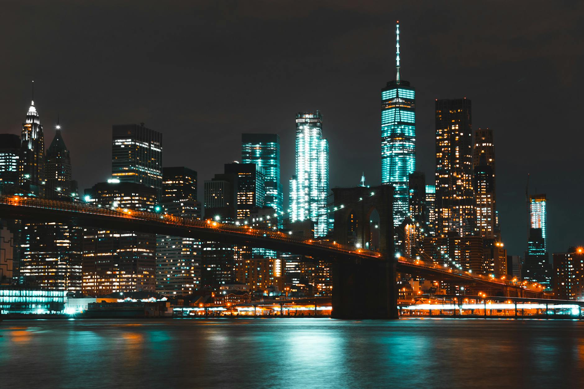 Captivating night skyline of New York City with Brooklyn Bridge and skyscraper reflections. Captivating night skyline of New York City with Brooklyn Bridge and skyscraper reflections.