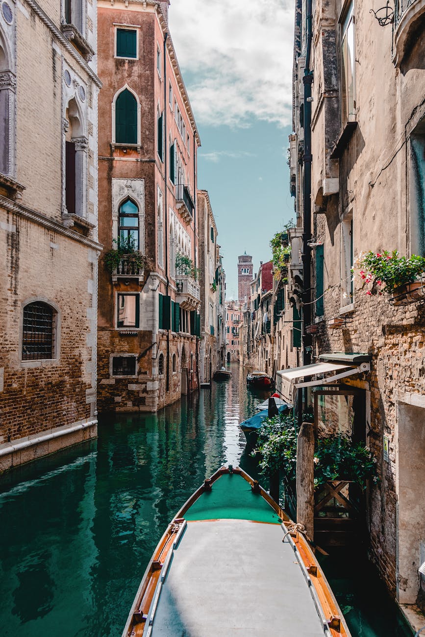 Captivating view of a traditional Venetian canal surrounded by historic buildings, perfect for travel enthusiasts. Captivating view of a traditional Venetian canal surrounded by historic buildings, perfect for travel enthusiasts.