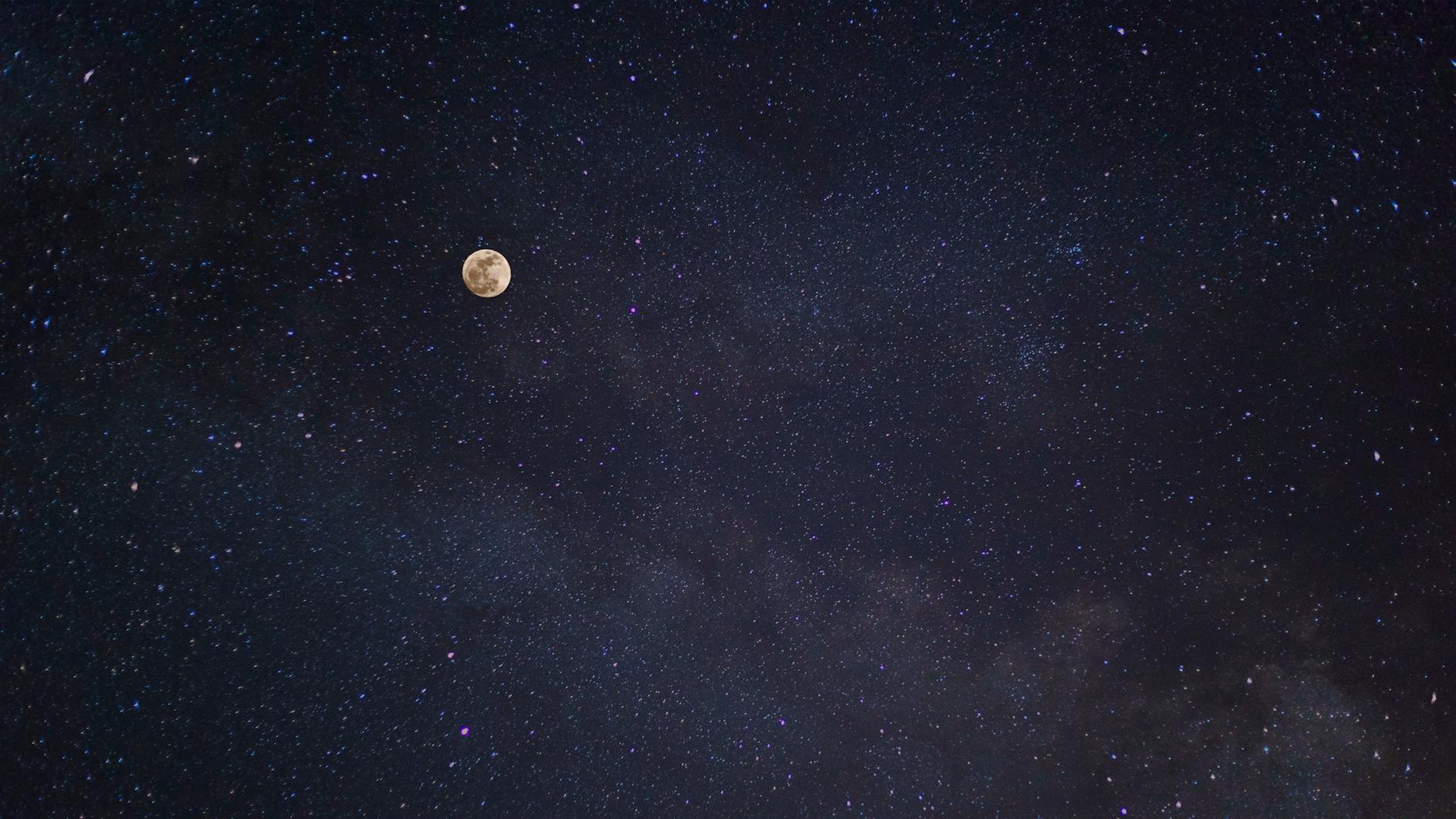 A breathtaking view of the full moon against a starry night sky with the Milky Way. A breathtaking view of the full moon against a starry night sky with the Milky Way.