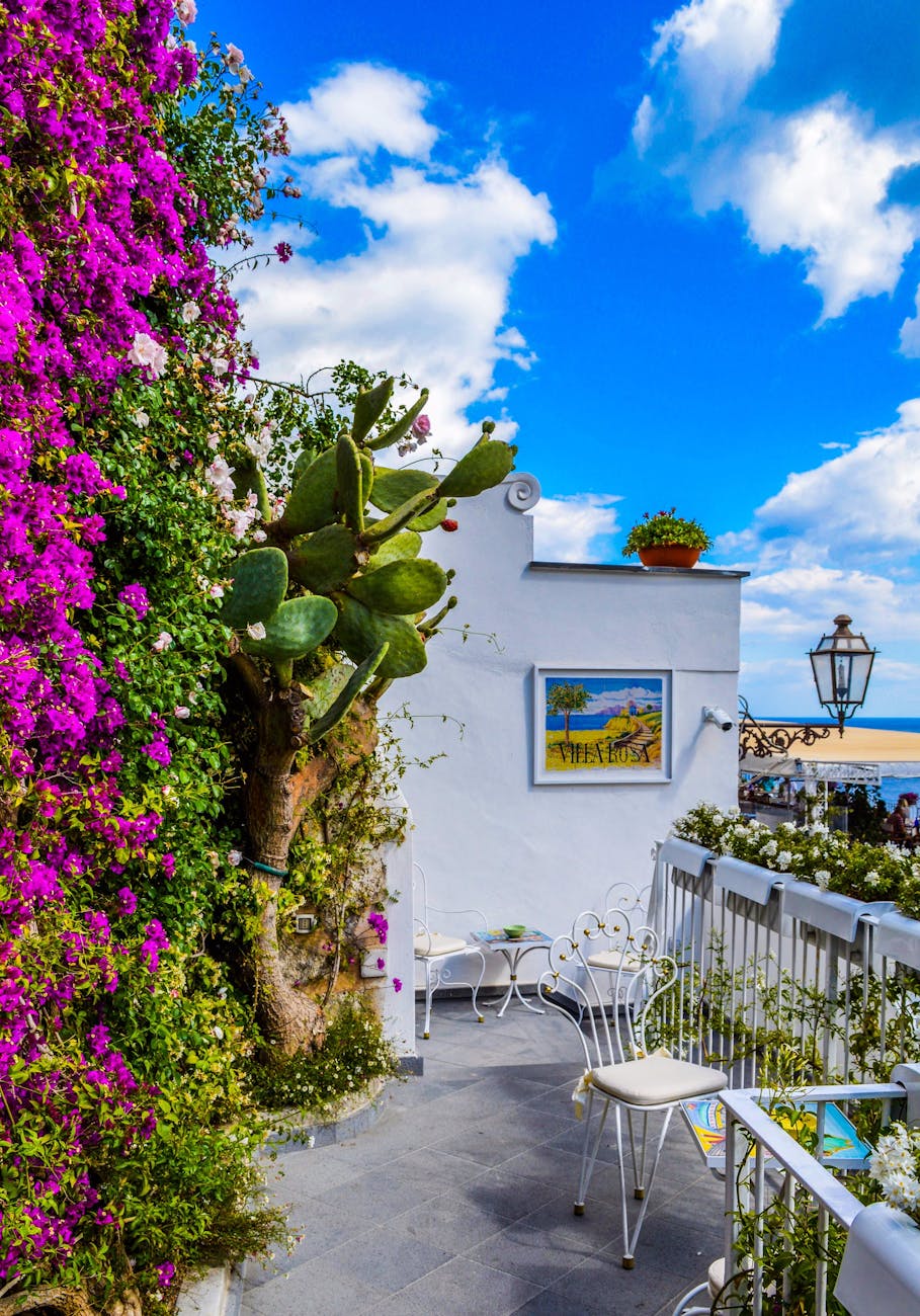 Charming Mediterranean balcony adorned with vibrant bougainvillea, overlooking sea. Charming Mediterranean balcony adorned with vibrant bougainvillea, overlooking sea.