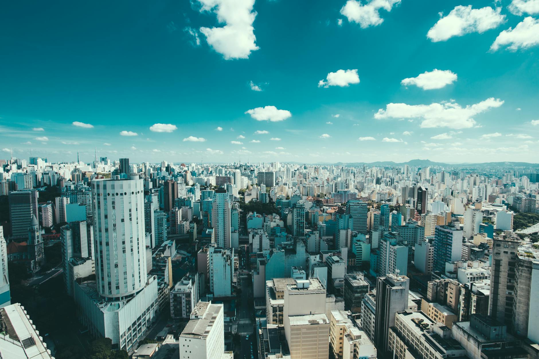 Expansive aerial view of Sao Paulo showcasing skyscrapers and a vibrant urban skyline under a blue sky. Expansive aerial view of Sao Paulo showcasing skyscrapers and a vibrant urban skyline under a blue sky.