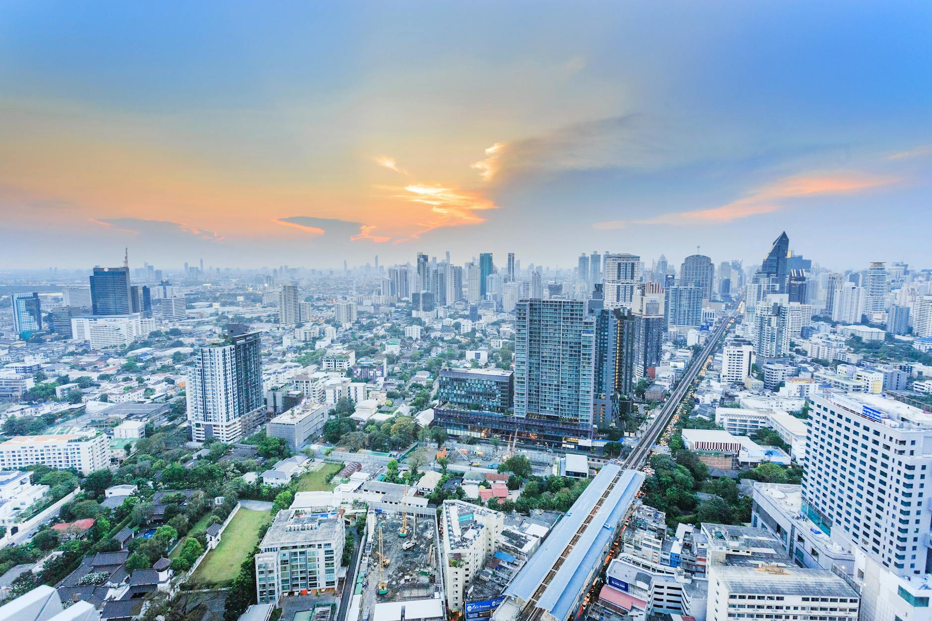 Stunning aerial view of Bangkok cityscape during twilight, showcasing the city’s modern skyline.