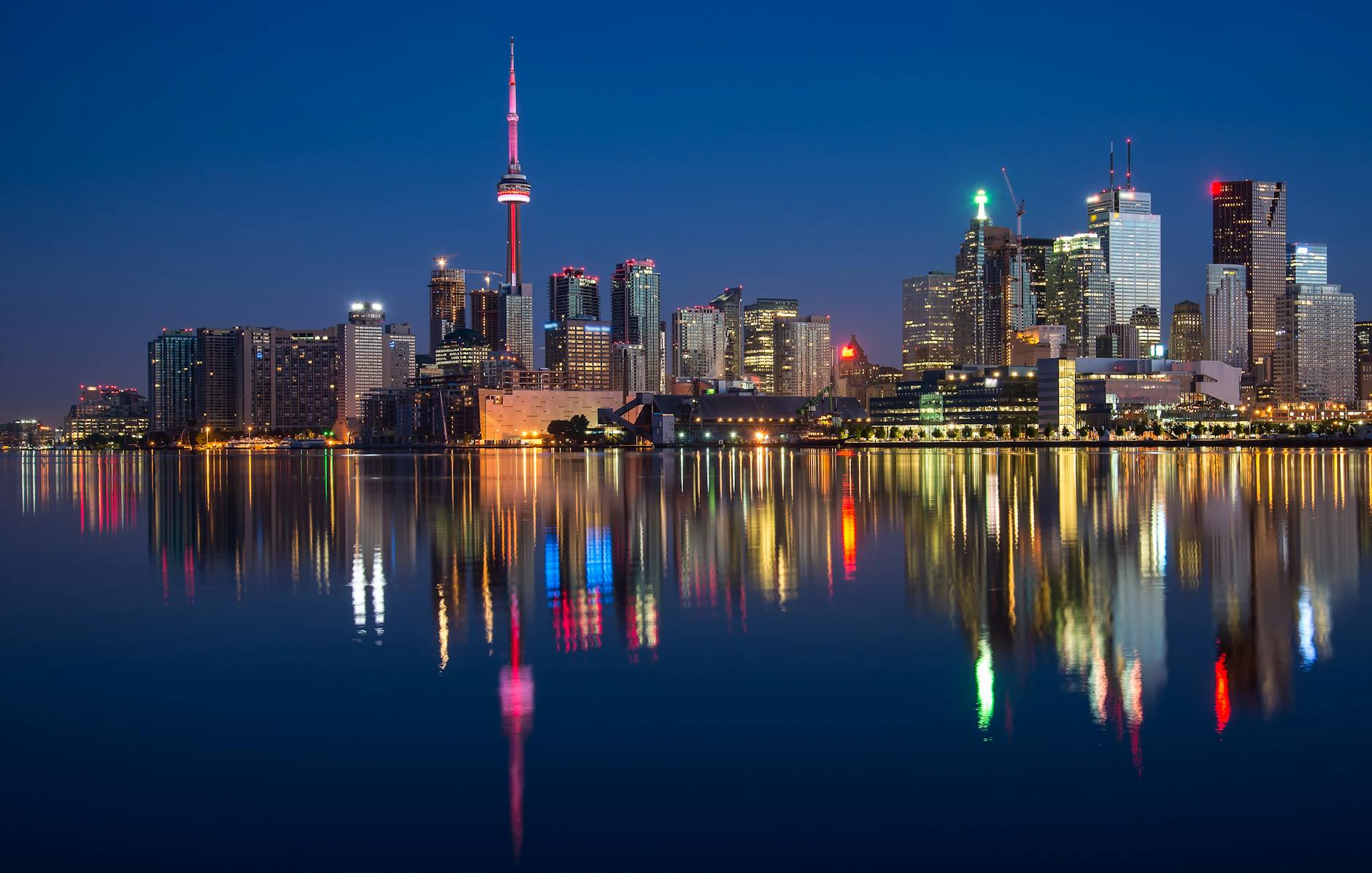 Stunning night view of Toronto skyline reflecting on water with CN Tower prominent. Stunning night view of Toronto skyline reflecting on water with CN Tower prominent.
