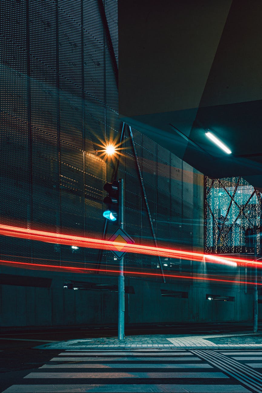 Dynamic night shot of a city street in Hradec Králové with vibrant light trails and urban architecture. Dynamic night shot of a city street in Hradec Králové with vibrant light trails and urban architecture.