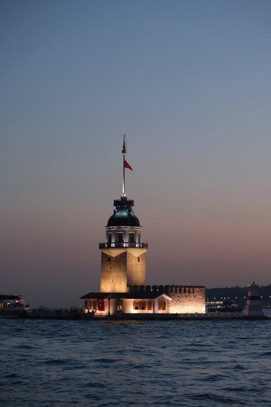 Stunning view of the illuminated Maiden’s Tower at sunset on Istanbul’s Bosphorus Strait. Stunning view of the illuminated Maiden’s Tower at sunset on Istanbul’s Bosphorus Strait.