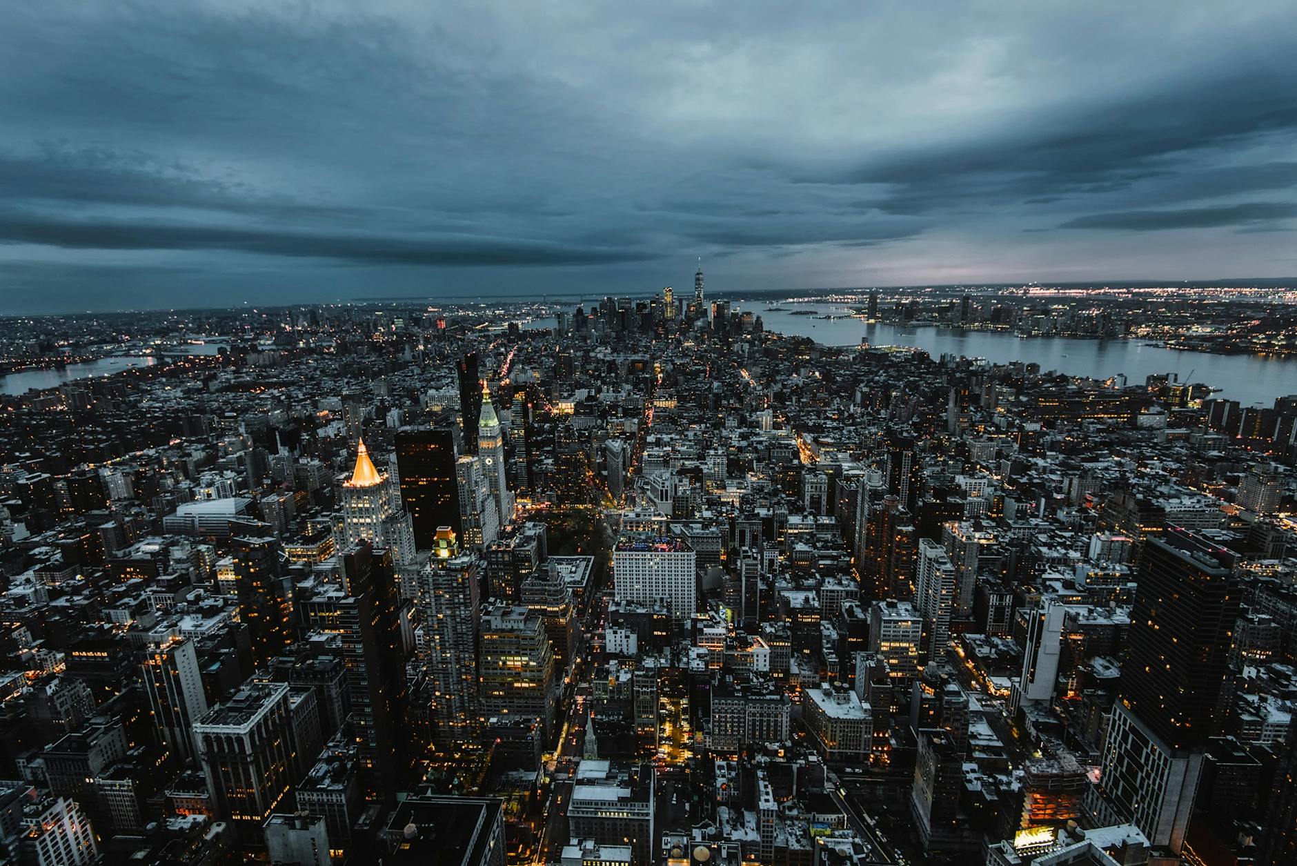 Stunning aerial view of New York City’s skyscrapers and skyline at dusk, showcasing the urban landscape.
