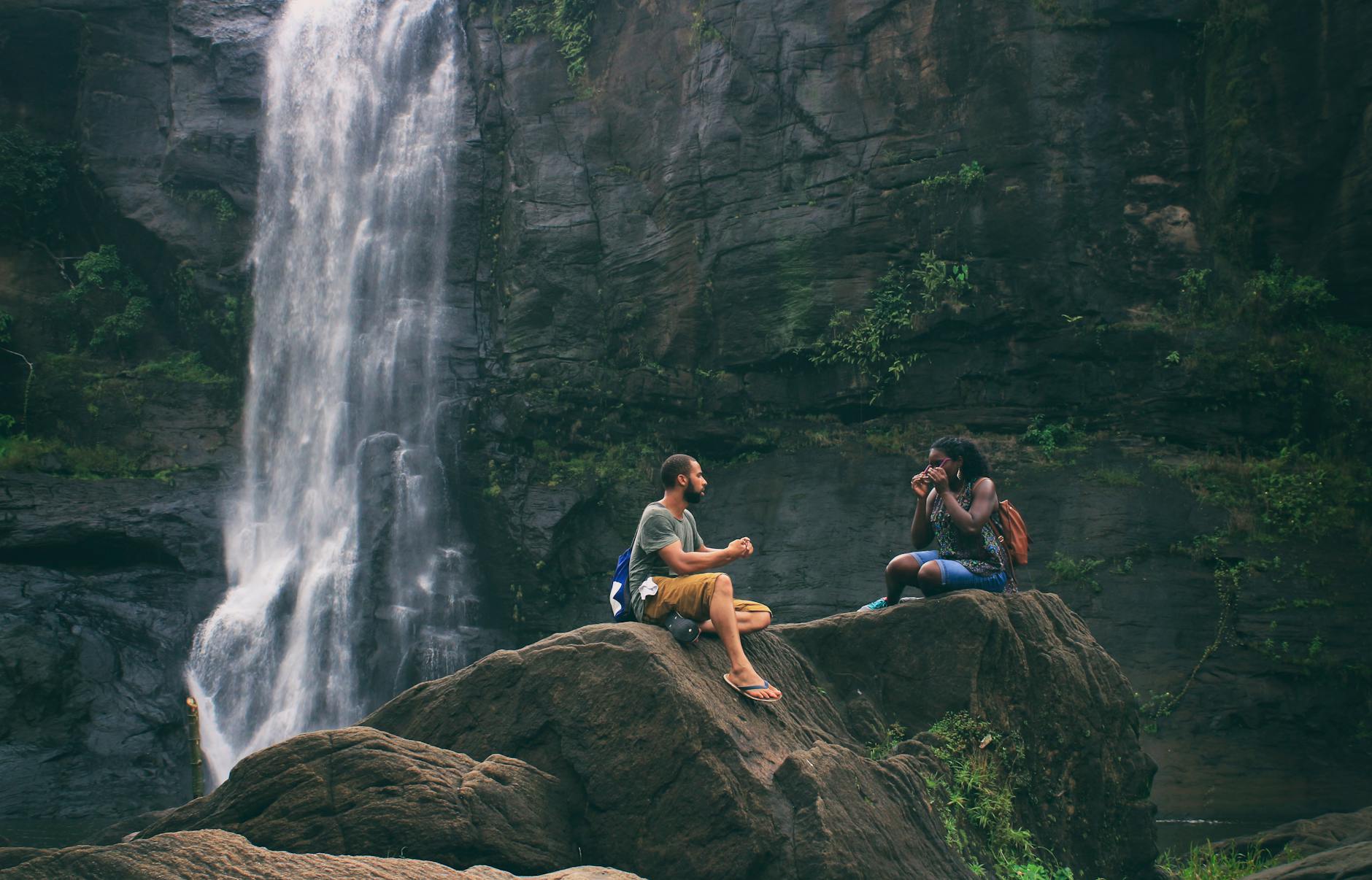 A serene moment captured by a waterfall in India with a couple enjoying nature’s beauty together. A serene moment captured by a waterfall in India with a couple enjoying nature’s beauty together.