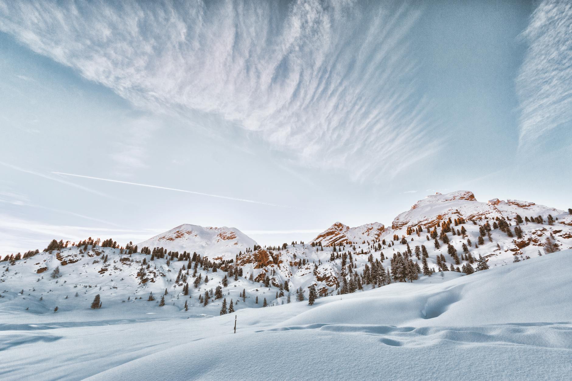 Breathtaking snowy mountain landscape with trees and clouds in the Dolomites. Breathtaking snowy mountain landscape with trees and clouds in the Dolomites.