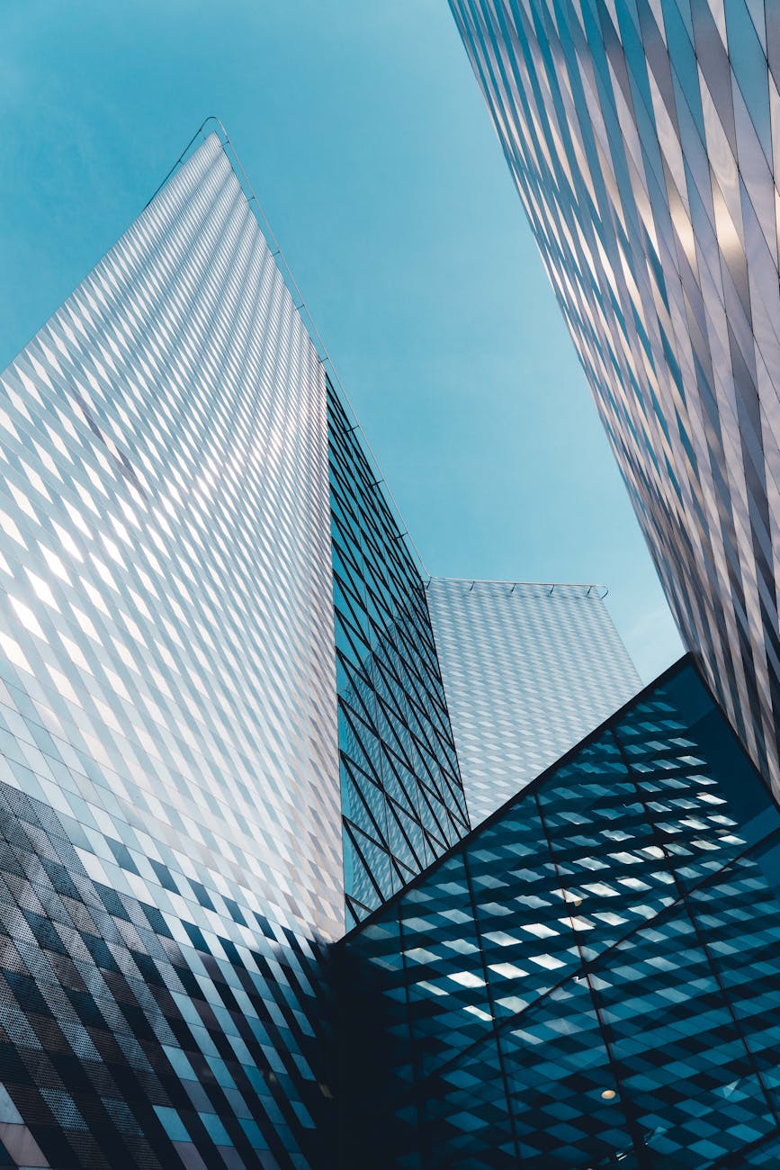 Futuristic skyscrapers in Vilnius with reflective geometric facades under a clear sky. Futuristic skyscrapers in Vilnius with reflective geometric facades under a clear sky.