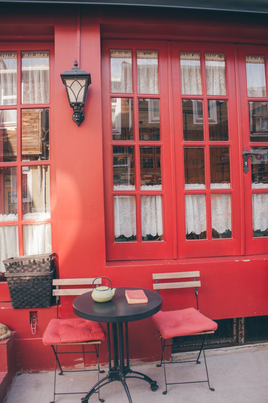 Red-themed coffee shop exterior with inviting seating area and vintage decor.