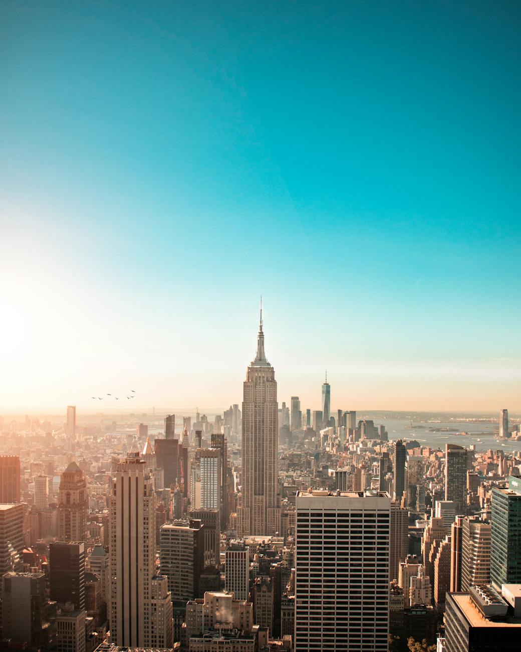 Breathtaking view of New York City’s skyline featuring the iconic Empire State Building at sunrise. Breathtaking view of New York City’s skyline featuring the iconic Empire State Building at sunrise.