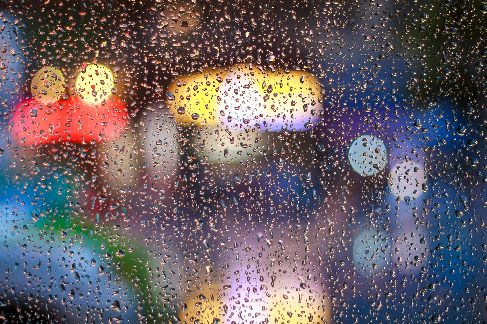 Raindrops on a window with vibrant city lights bokeh in Tân Bình, Vietnam. Raindrops on a window with vibrant city lights bokeh in Tân Bình, Vietnam.