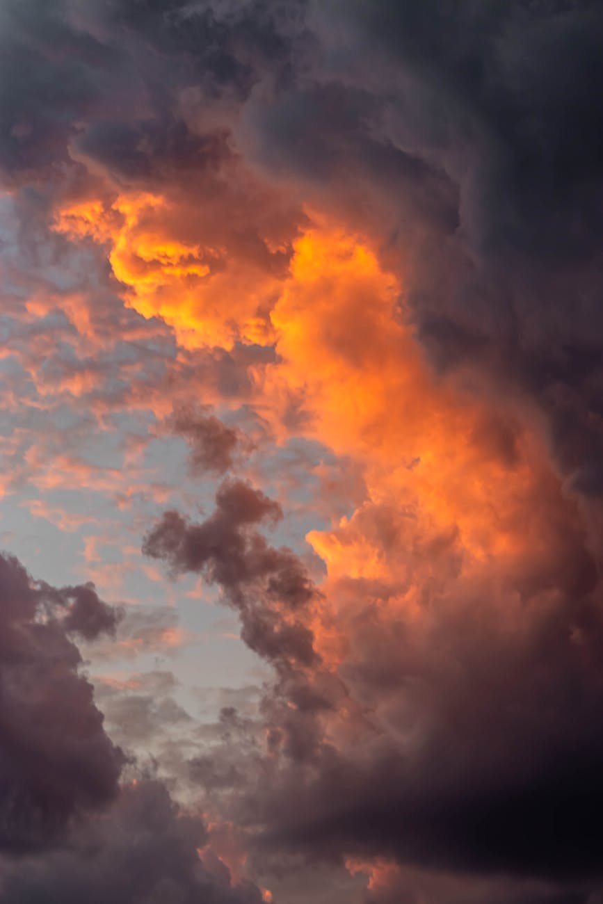 Captivating cloud formation at sunset showcasing vibrant orange and dark clouds.
