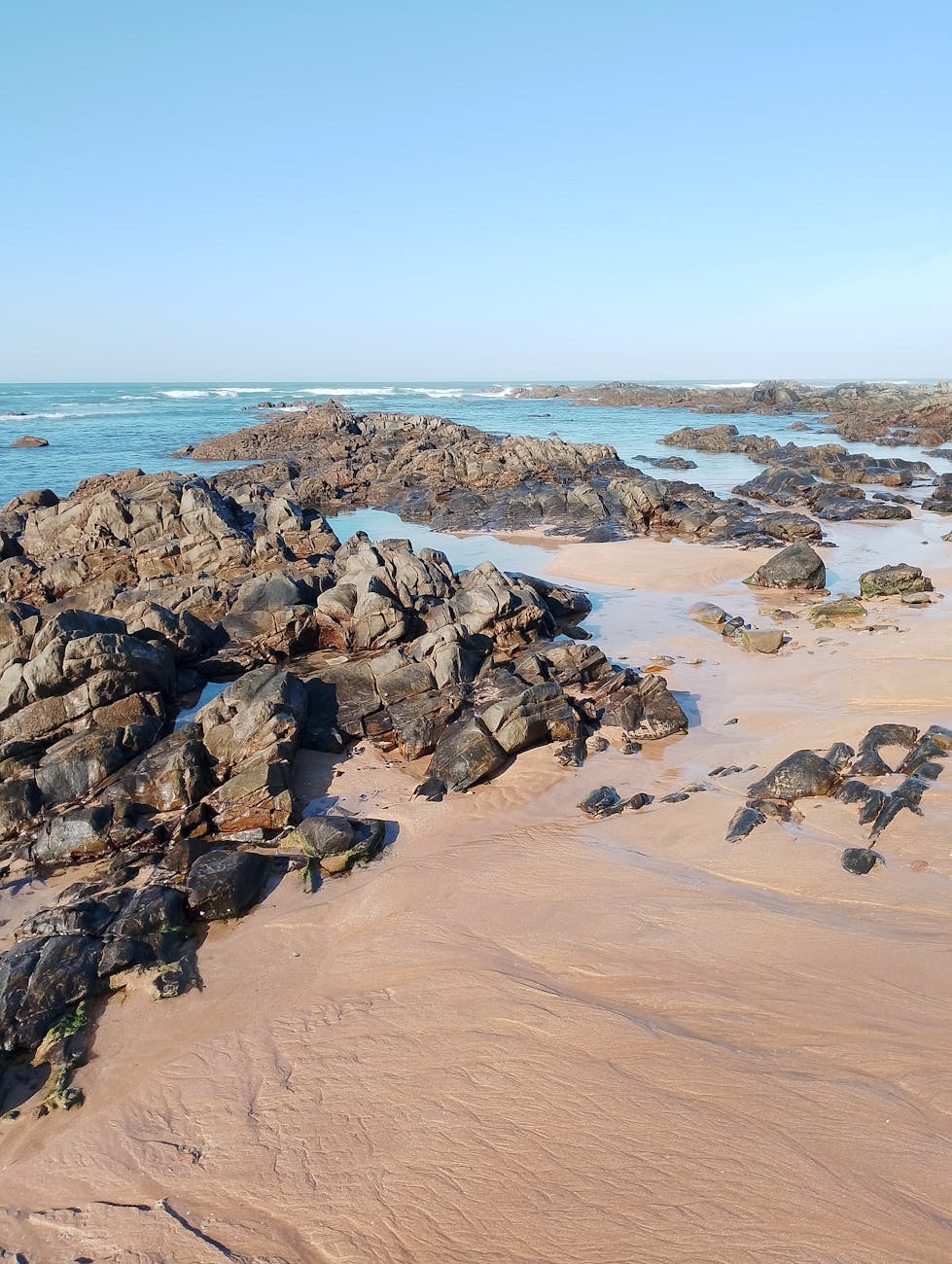 Breathtaking view of rocky coastline with crystal clear waters in Casablanca, Morocco.