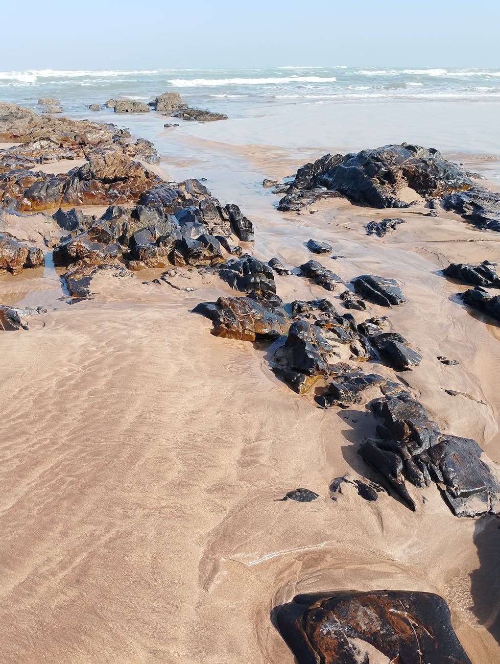 Enchanting beach: golden sands alluring, emerald rocks stunning, tides reveal amazing sandy deposits, waves roll gently, sky azure breathtaking. Enchanting beach: golden sands alluring, emerald rocks stunning, tides reveal amazing sandy deposits, waves roll gently, sky azure breathtaking.