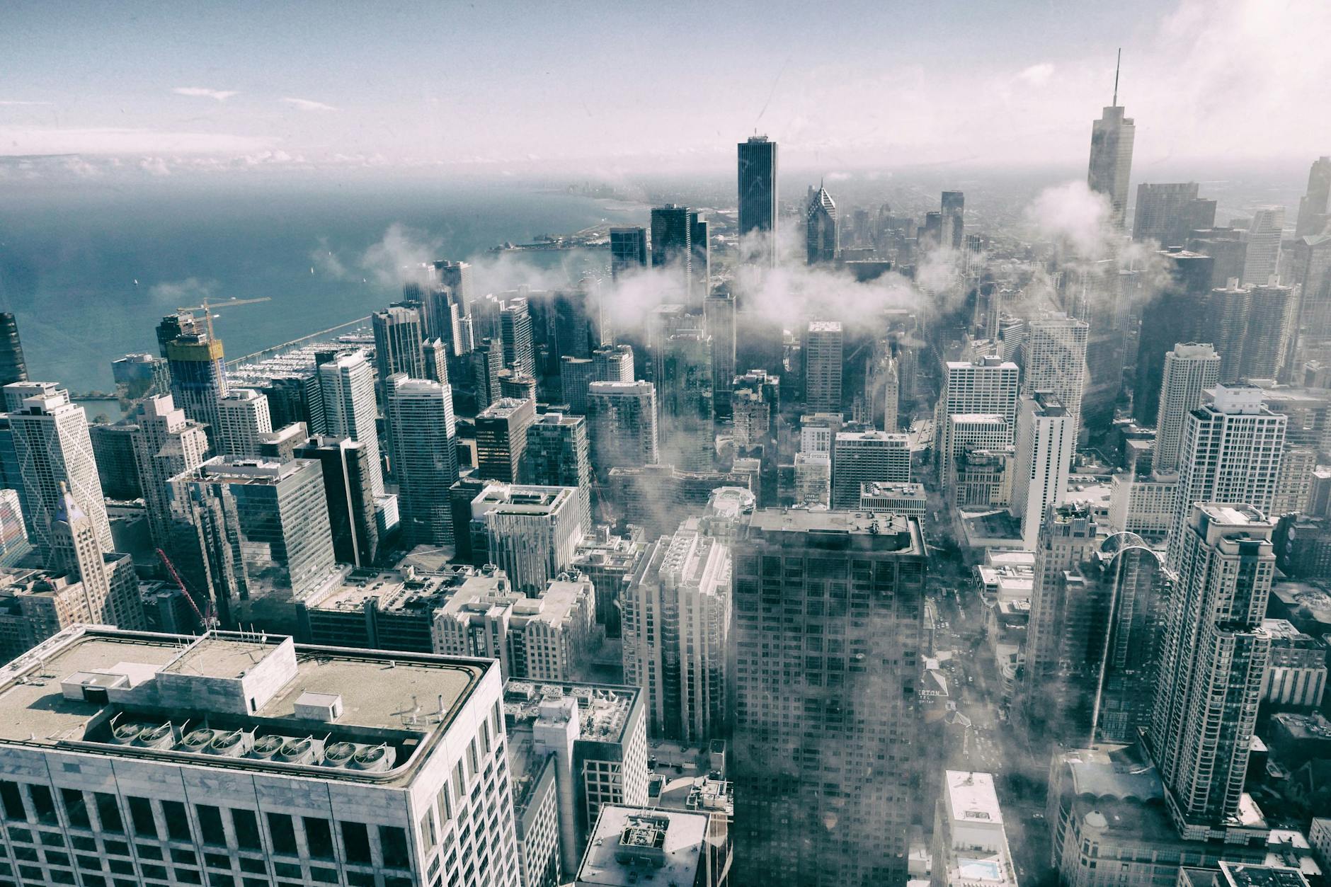 Stunning aerial perspective of Chicago’s skyline with clouds, showcasing urban architecture.