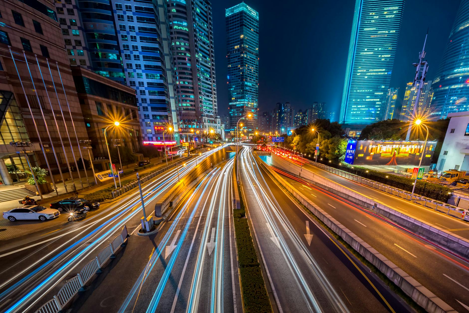 Dynamic long exposure night shot of urban cityscape with vibrant light trails and towering skyscrapers. Dynamic long exposure night shot of urban cityscape with vibrant light trails and towering skyscrapers.