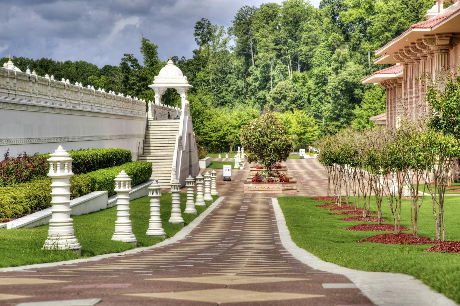 Peaceful garden view showcasing ornate architecture and lush greenery on a sunny day. Peaceful garden view showcasing ornate architecture and lush greenery on a sunny day.