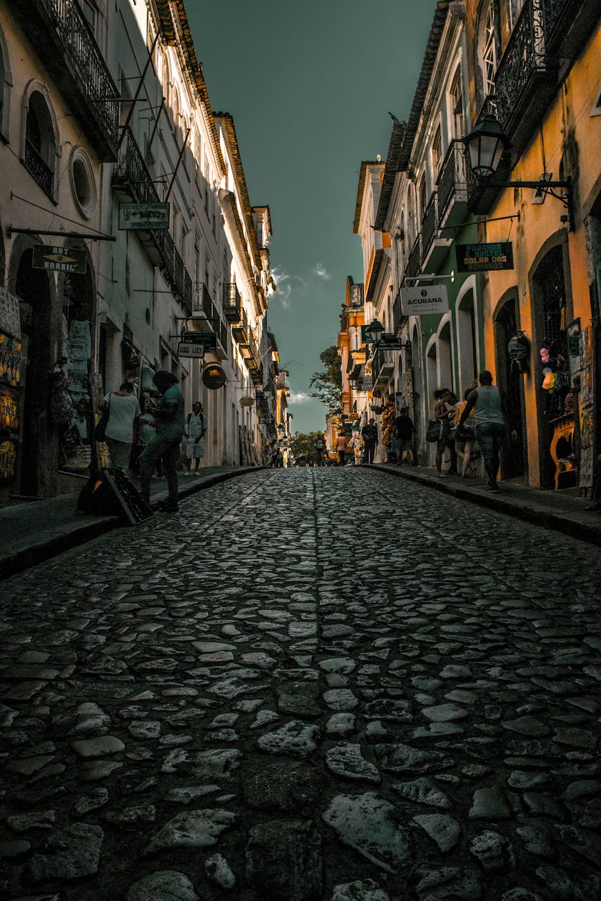 Explore historic cobblestone streets lined with lit buildings in an enchanting evening setting. Explore historic cobblestone streets lined with lit buildings in an enchanting evening setting.