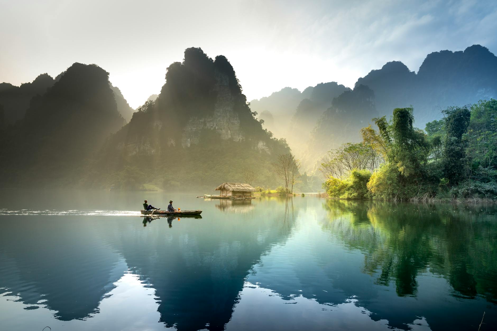 Tranquil lake with mountains reflecting at sunrise in Tuyên Quang, Vietnam. Tranquil lake with mountains reflecting at sunrise in Tuyên Quang, Vietnam.