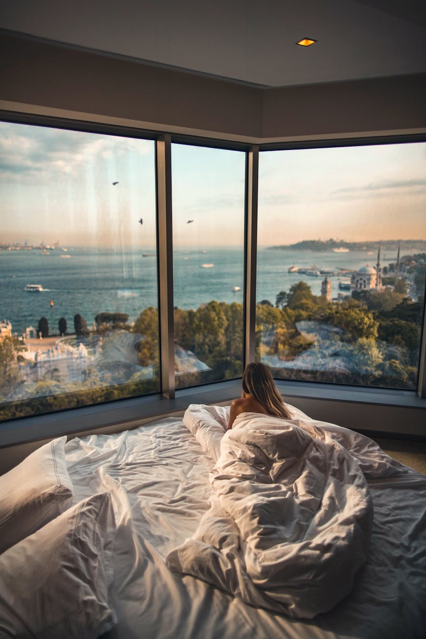 Relaxing in a cozy hotel room with stunning views of the Bosphorus at sunset in Istanbul, Turkey. Relaxing in a cozy hotel room with stunning views of the Bosphorus at sunset in Istanbul, Turkey.