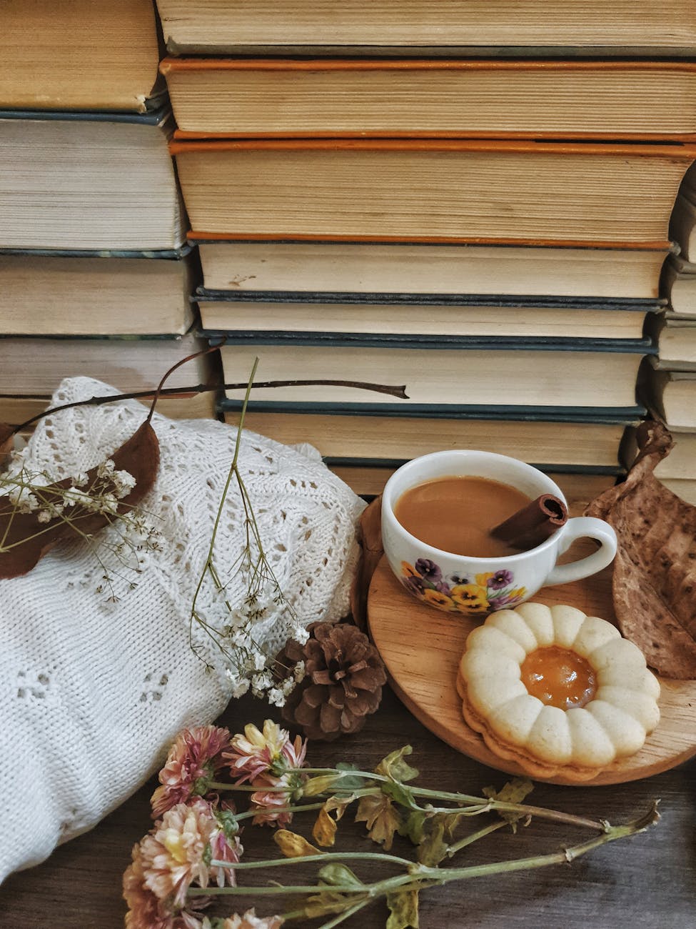 Warm and inviting autumn scene featuring a coffee cup, stack of books, and cozy elements. Warm and inviting autumn scene featuring a coffee cup, stack of books, and cozy elements.